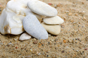 Fototapeta na wymiar Stones on the sand in natural light