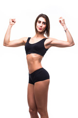 Full length of young beautiful woman in sportswear doing exercises while white background