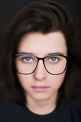 Fototapeta na wymiar Portrait of a teen boy wearing glasses. Close-up shot 