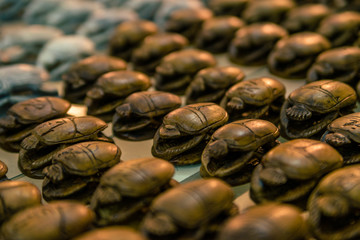 Rows of wooden Egyptian scarabs