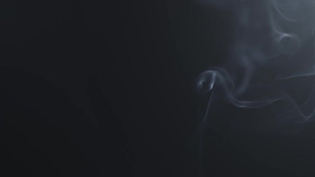 blue smoke rising over black background with lens flare in corner in 180fps slow motion, prores footage