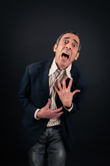 Handsome man doing different expressions in different sets of clothes: heart attack