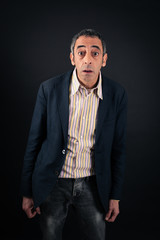 Fototapeta premium Handsome man doing different expressions in different sets of clothes: surprise