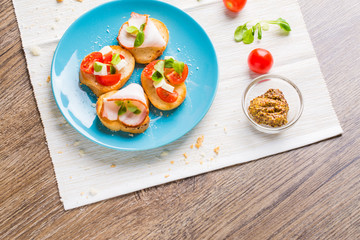 Bruschetta with tomato, cheese and bacon