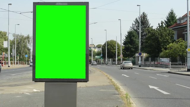 view of the billboard in the middle of the busy road - green screen - timelapse