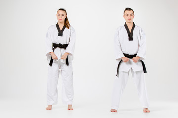 The karate girl and boy with black belts