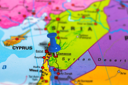 Damascus in Syria pinned on colorful political map of Asia. Geopolitical school atlas. Tilt shift effect.