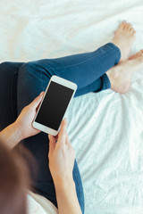 Woman with modern mobile phone in hands