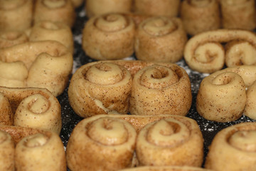 raw cookie dough with cinnamon formed in brezel shape waiting to be cooked in the oven.