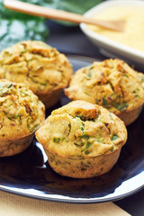 Vegan muffins with spinach and corn flour served on black plate