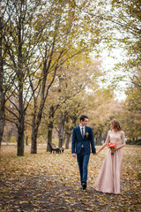 Fototapeta premium Romantic embrace of newlyweds. Couple walks in the park.