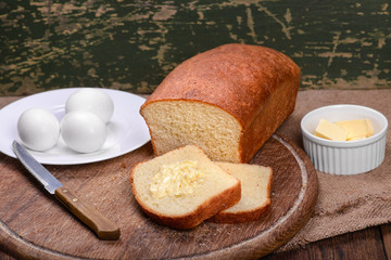 Sliced white bread on wooden board table still life