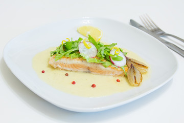 Grilled salmon steak with beurre blanc sauce, selective focus