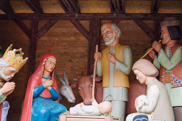 Obraz na płótnie Canvas Christmas nativity scene with baby Jesus, Mary and Joseph in barn.