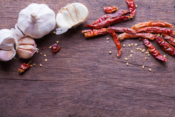 garlic and dried chilli on wooden background