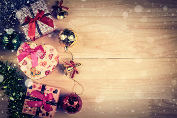 Christmas background with decorations and gift boxes on wooden b