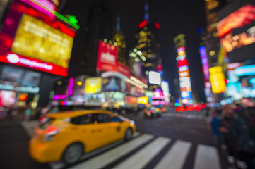 Defocus view of Times Square signage, traffic, and holiday crowds in the lead-up to New Year's Eve in New York City, USA