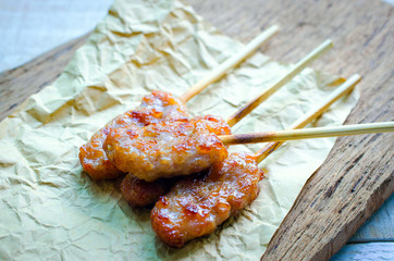 Thai styled pork babeque on brown place on old wooden