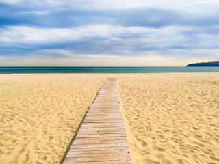 Fototapety  Wooden boardwalk to the sea on a sandy beach