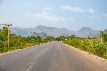 Roadway leading through mountains in Loas.