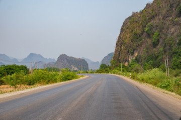 Roadway leading through mountains in Loas.