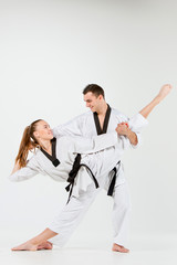 The karate girl and boy with black belts