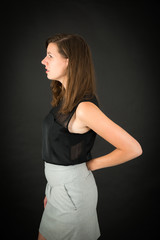 Naklejka premium Beautiful woman doing different expressions in different sets of clothes: backache
