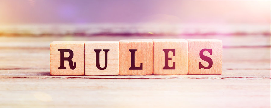 Word Rules With Wood Cubes On Table