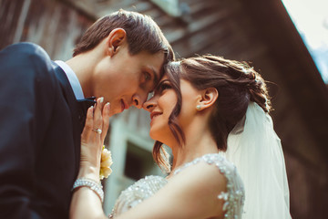 nice portrait of handsome and young groom and his beautiful brid