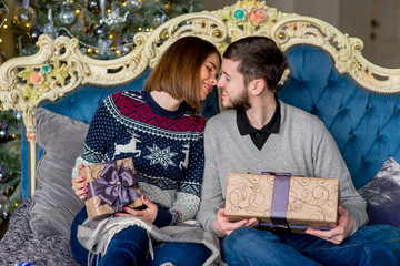 Couple of lovers sitting on the sofa. Christmas time