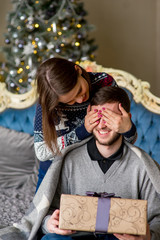 Woman make a surprise to the man for Christmas