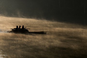 silhouette of bamboo rafting on the lake in morning