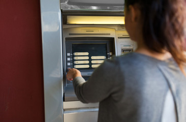 close up of woman choosing option on atm machine