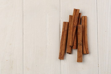 Cinnamon sticks on the table. Close up. White background