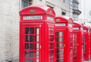 Fototapeta na wymiar Five Red London Telephone boxes all in a row