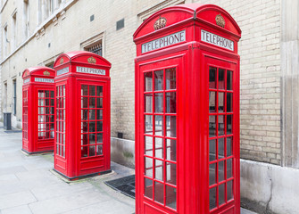Fototapeta premium Three Red London Telephone boxes all in a row