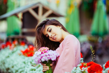 The charming lady keeps a bouquet