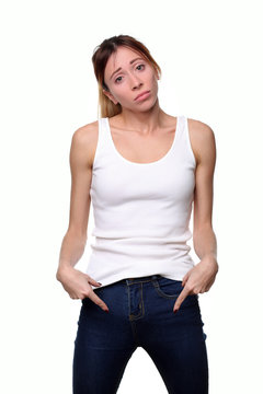 Girl wearing tanktop with hands in pockets. Close up. White background