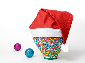 Egyptian decorated colorful pottery vase wearing Santa hat