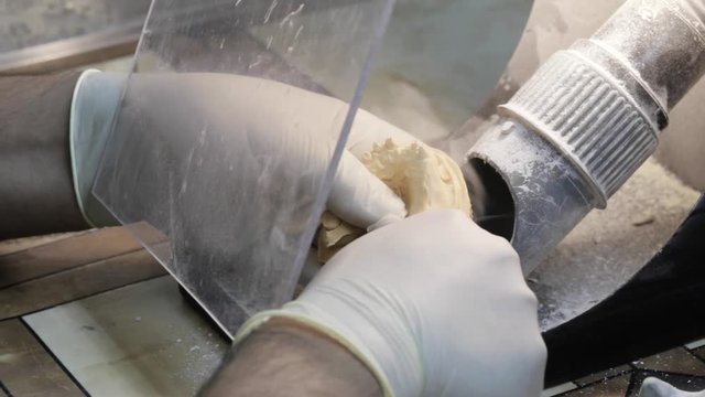 Close-up of ceramet implant creature process at laboratory. Technician creating a model of jaw with gipsum for create ceramet implant.