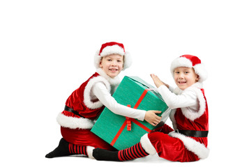 Adorable happy laughing boys in santa clothes holding Christmas gift box. Isolated white background.