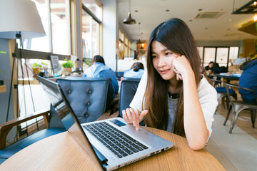 Smiling asian student woman casual browsing the internet