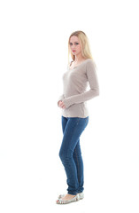 full length portrait of pretty blonde girl wearing casual brown shirt and jeans. standing pose isolated against white background