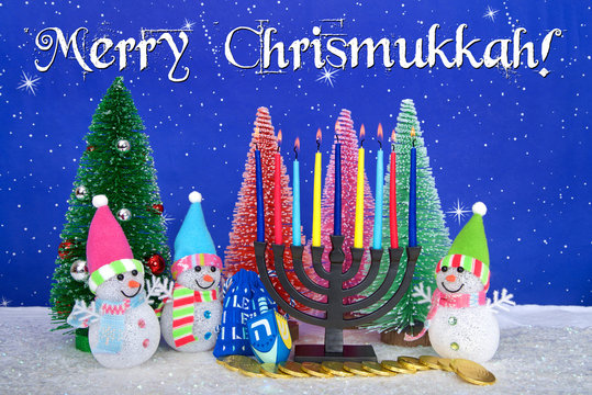Menorah and  red, pink, green pine trees with snowman on faux snow blue background white dots and stars. Christmas and Hanukkah together. Multi faith celebration. Merry Chrismukkah