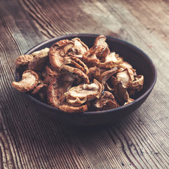 Full bowl od dried apple on the wooden table. Rustic style
