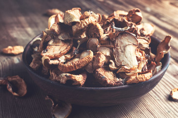 Full bowl of dried apple on the wooden table. Rustic style