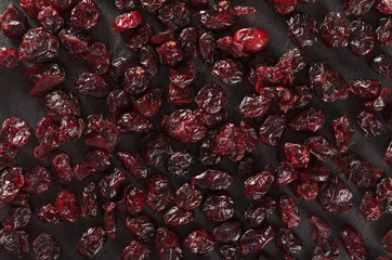 Dried cranberries on a slate plate, top view
