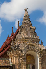 Ancient carved art of decoration  at the top of Main hall entrance area in Wat Pra Tad Lampang Luang, Lampang, Thailand