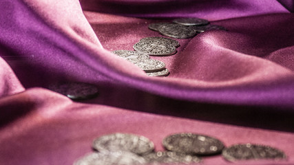 Ancient coins on purple satin