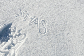 Scritta Xmas e impronta ciaspole da neve nella neve fresca delle montagne, Passo del Sempione, Alpi, Svizzera